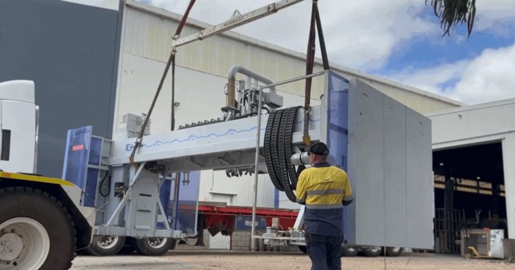 A HOMAG Weinmann Line being lifted onto a truck for relocation.